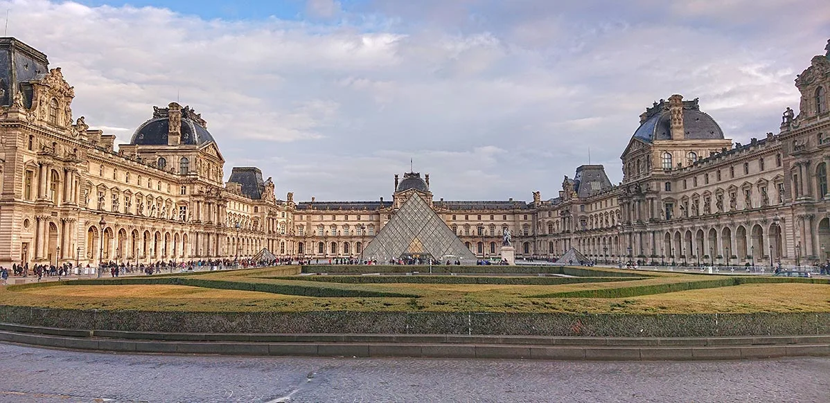 The iconic glass pyramid entrance of The Louvre Museum