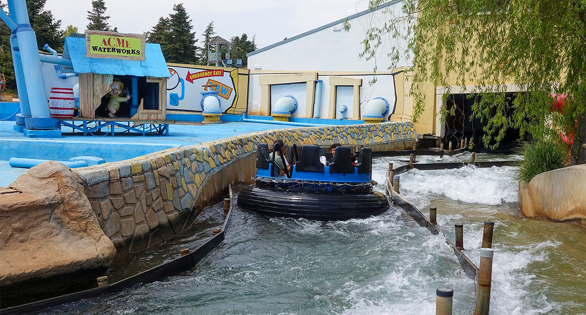 Riders getting soaked on the ACME Rapids water ride in the Cartoon Village area