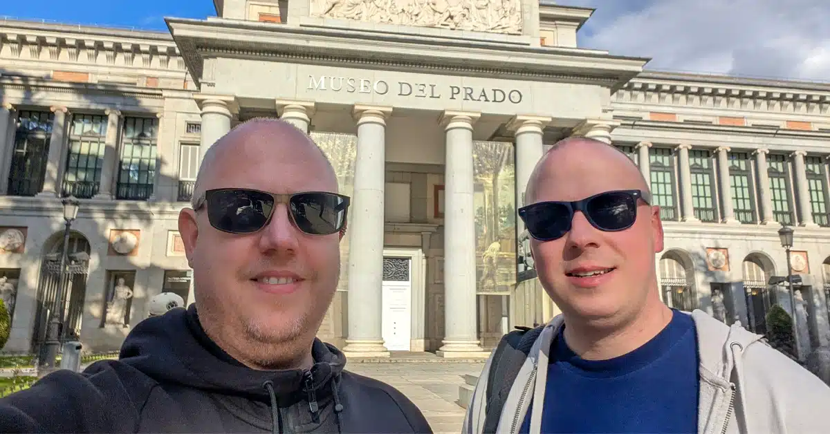 Kolyn and Denis of The Curious Tourists standing outside the Prado Museum - Madrid Travel Guide