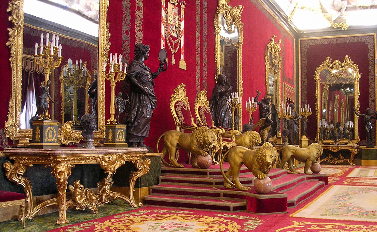 Red velvet walls and chandeliers in the Throne Room of the Royal Palace of Madrid