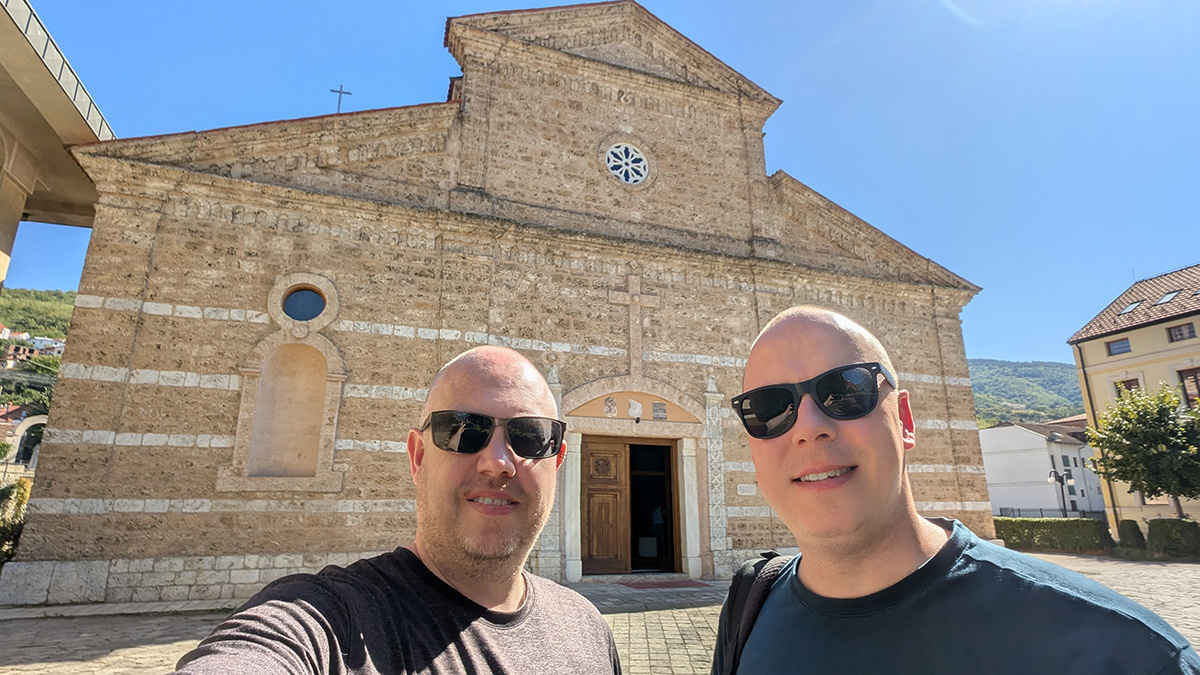 Denis and Kolyn standing in front of the Cathedral of Our Lady of Perpetual Succour on our Prizren day trip