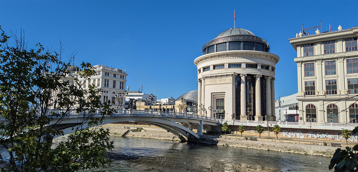 A classical style building and the Art Bridge - Skopje travel guide