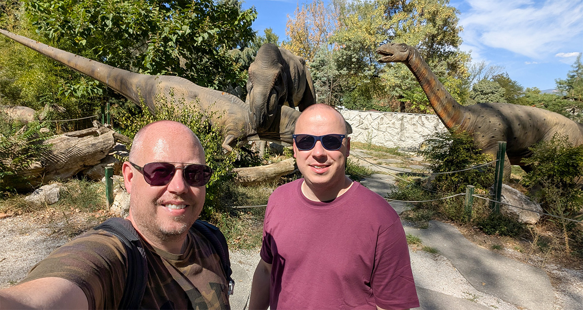 Kolyn and Denis exploring the animatronic dinosaurs at the Dino Park in Skopje