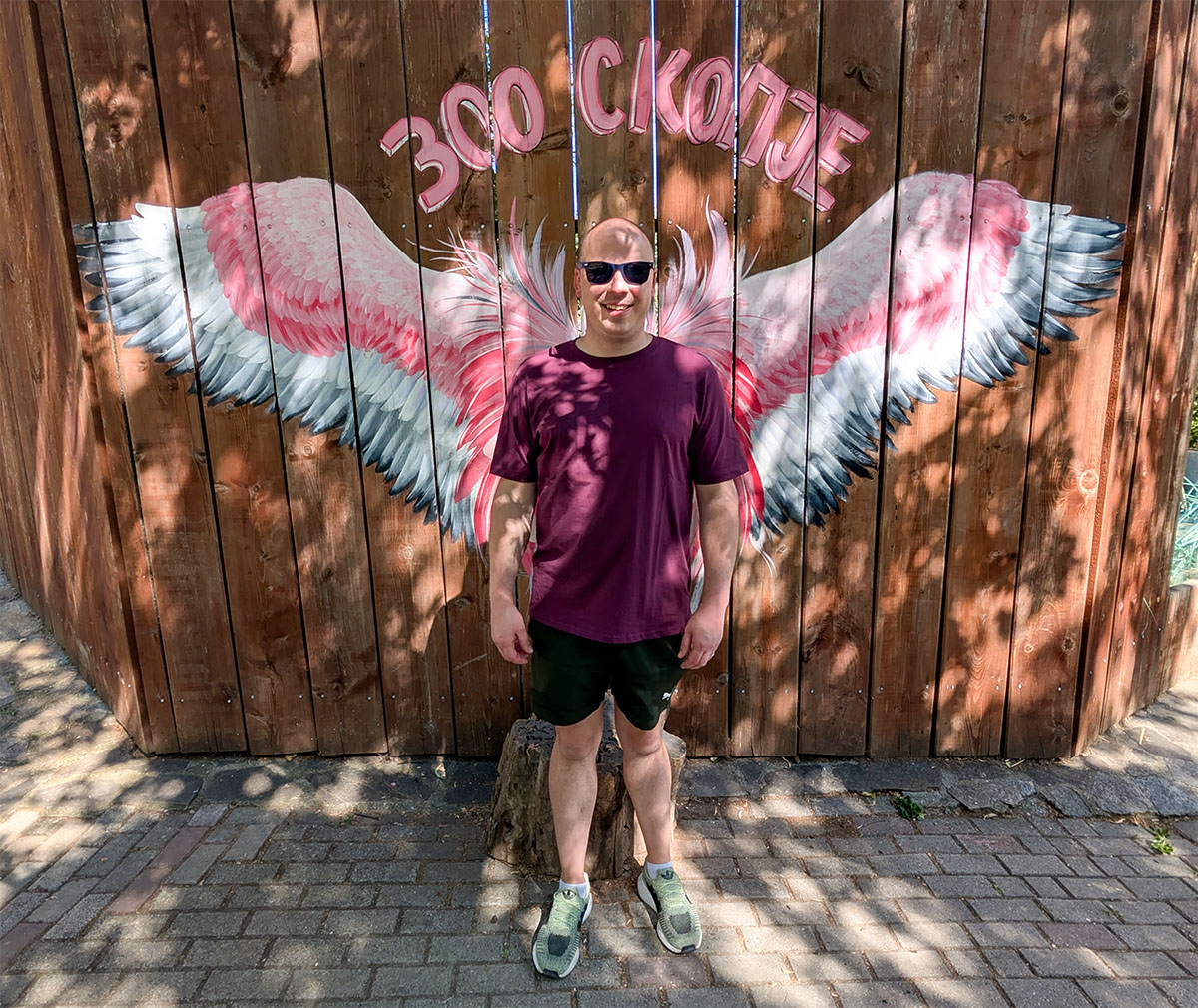 Denis posing with large painted flamingo wings at Skopje Zoo
