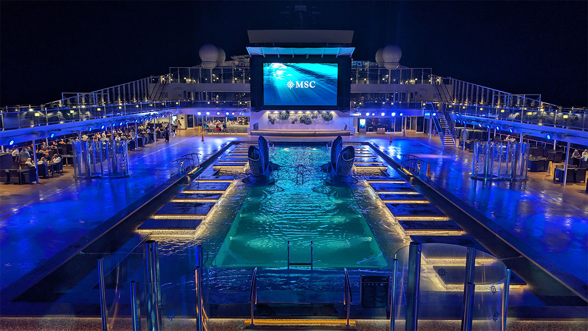 Atmosphere Pool deck illuminated at night on MSC Virtuosa