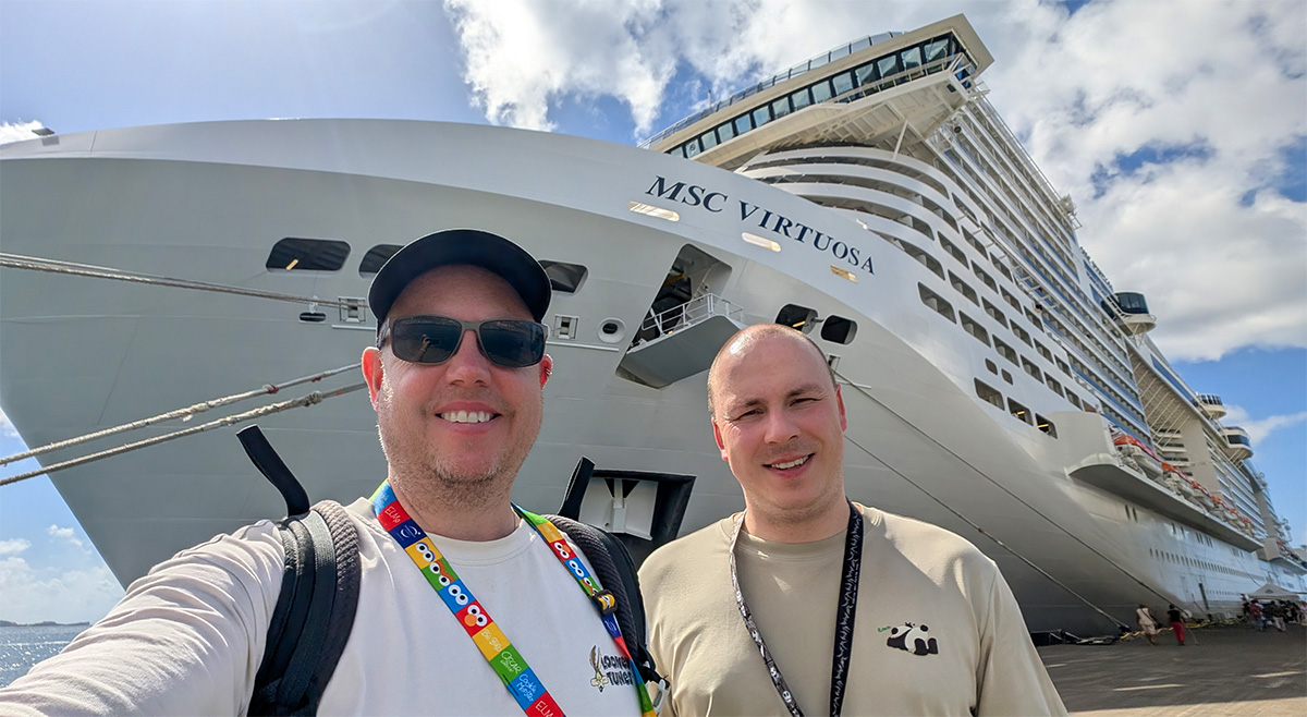 Curious Tourists travel bloggers standing in front of the MSC Virtuosa cruise ship
