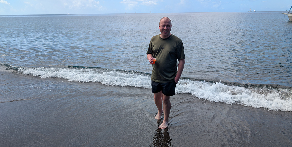 Denis enjoying a rum punch at Mount Wynne black sand beach St Vincent