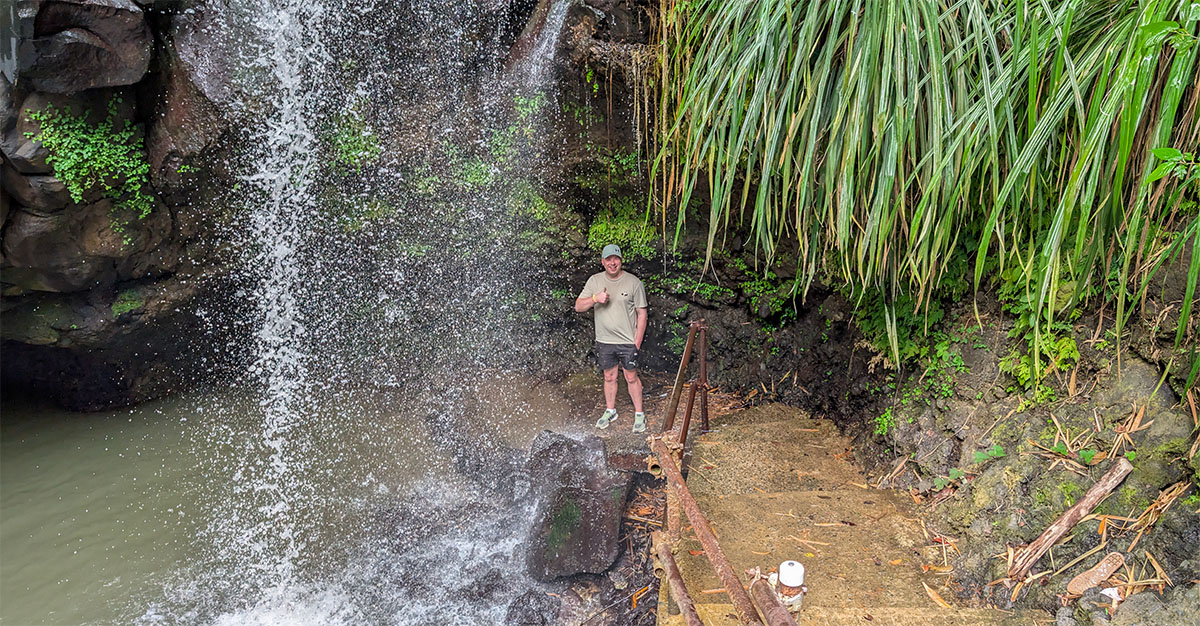 Denis standing by Annandale Waterfalls during a Grenada rainforest shore excursion