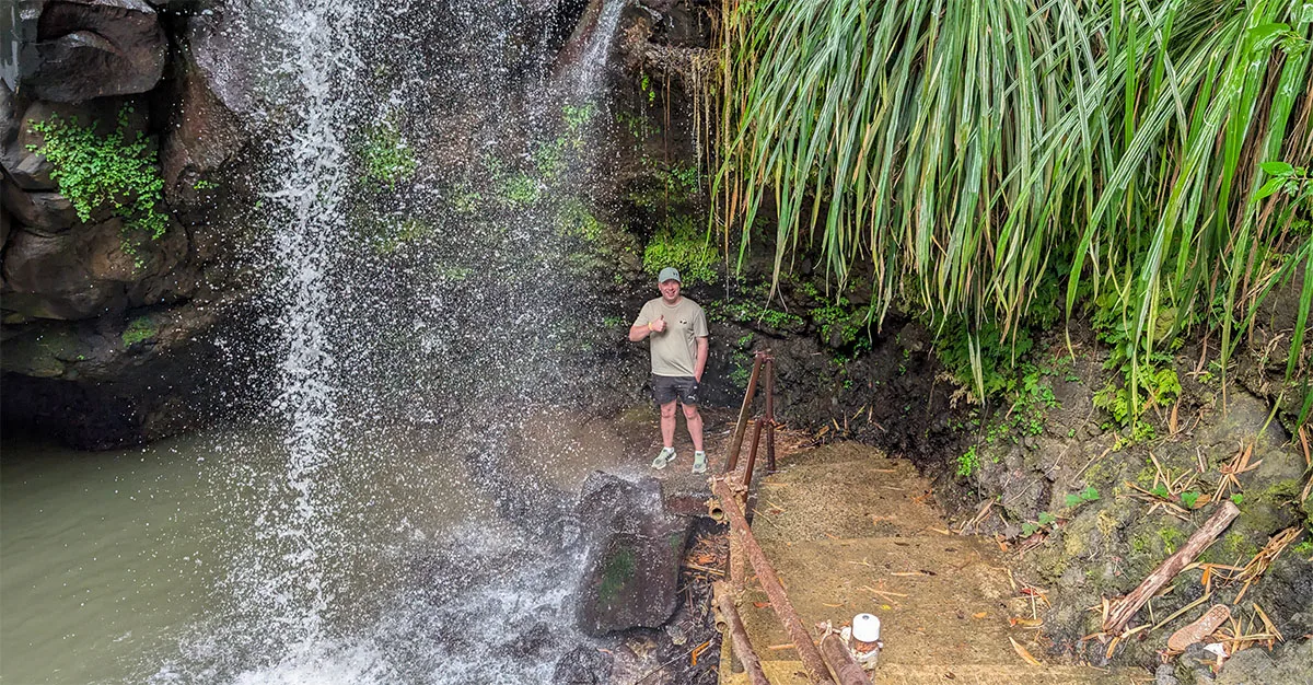 Denis standing by Annandale Waterfalls during a Grenada rainforest shore excursion
