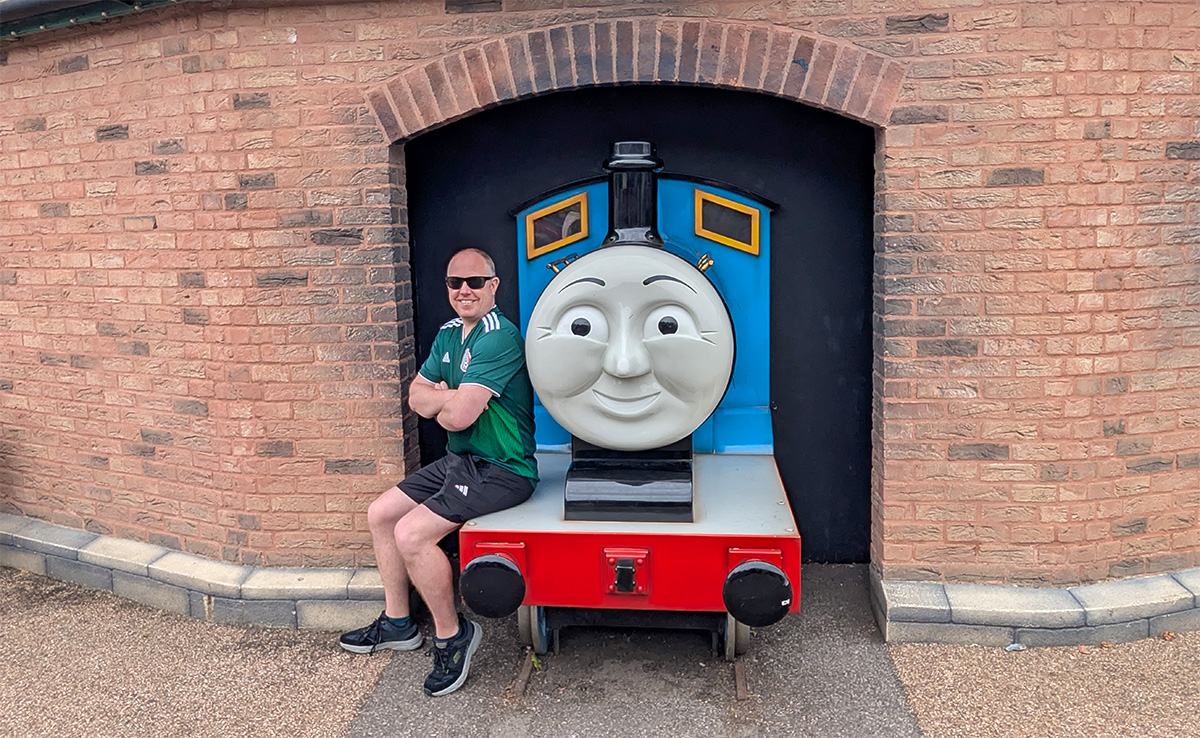 Kolyn sitting on the Gordon the Big Engine model in Thomas Land at Drayton Manor